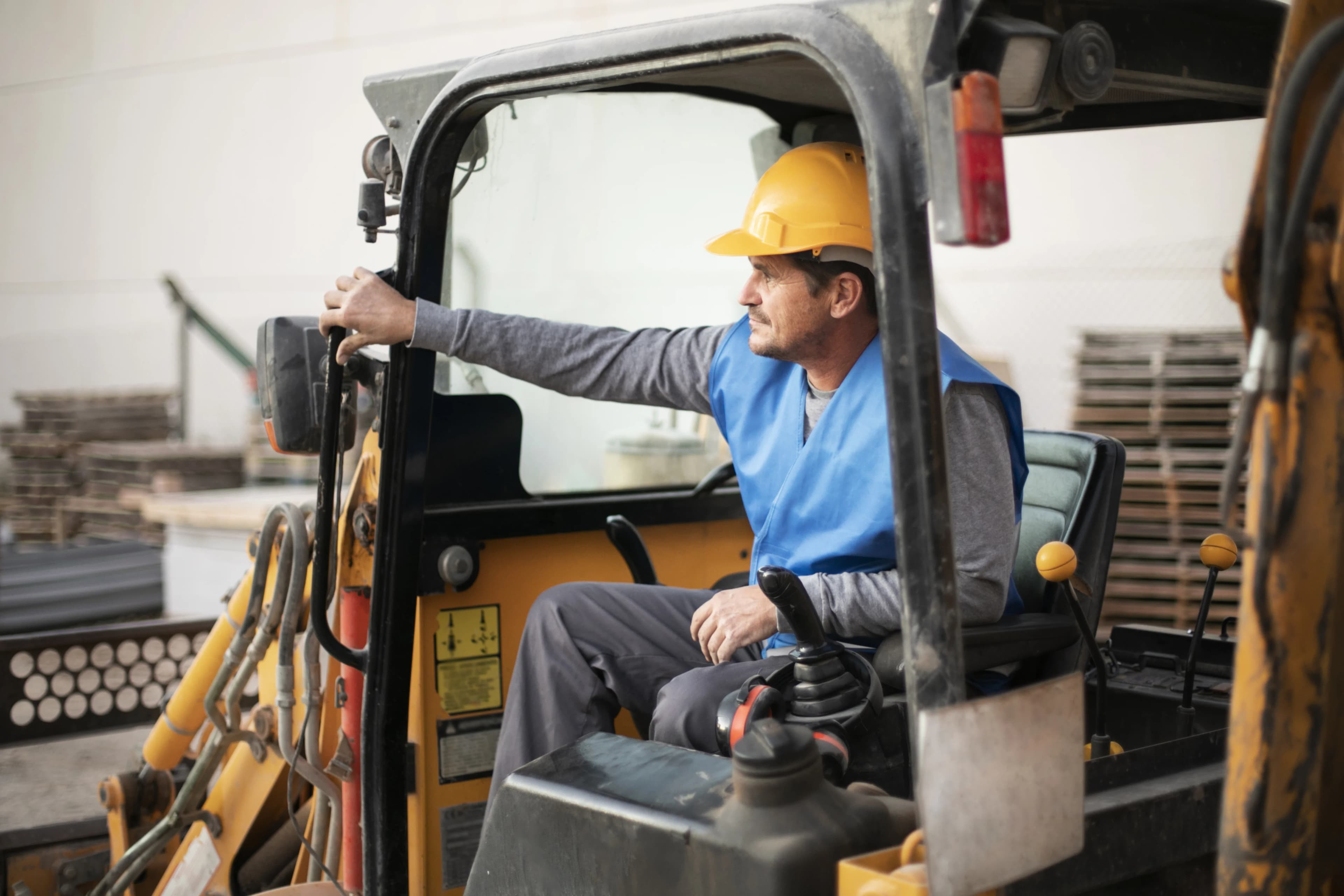 Construction worker operating machinery